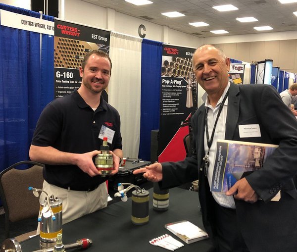 Ben Reasoner with Curtiss-Wright welcomes Morteza Sameei with Houston Community College to his booth at the PMIES Expo