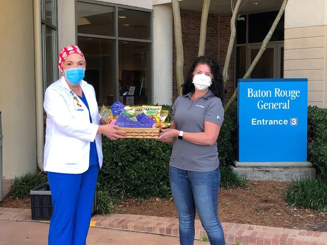 Healthcare workers at Baton Rouge General receive a care package with snacks and Exxon and Mobil gas gift cards.